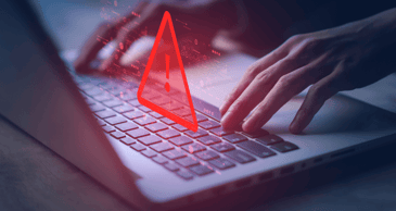 Laptop with warning triangle for hacked 